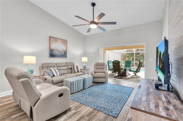living room with high vaulted ceiling, ceiling fan, and wood finished floors