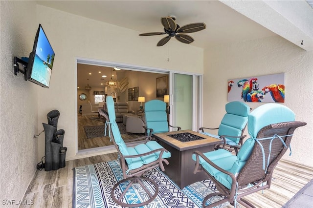view of patio / terrace featuring ceiling fan and a fire pit