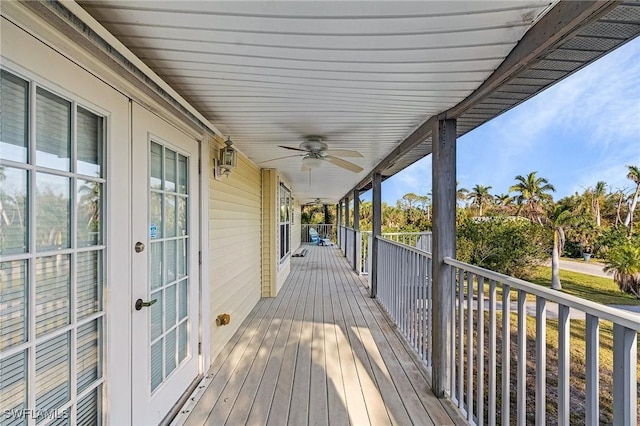 wooden deck featuring a ceiling fan and french doors