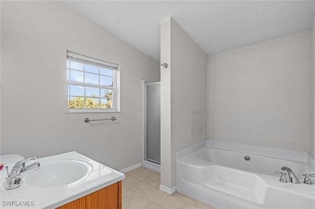 full bathroom with a stall shower, a bath, baseboards, tile patterned flooring, and vanity