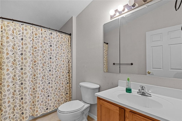 bathroom featuring toilet, vanity, and a shower with curtain