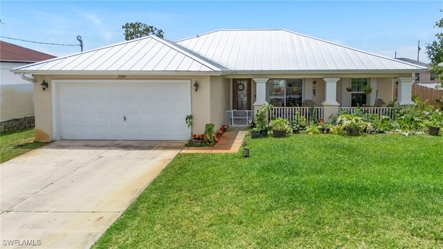 3303 32nd St SW, Lehigh Acres, FL 33976 - view of front facade with covered porch, a standing seam roof, stucco siding, a garage, and driveway