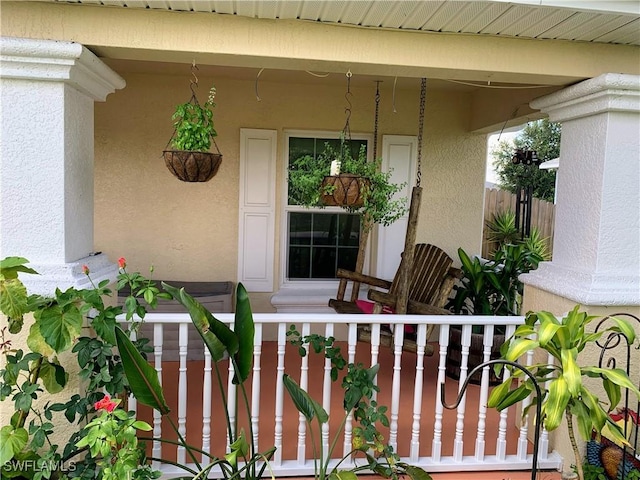 3303 32nd St SW, Lehigh Acres, FL 33976 - doorway to property featuring a porch and stucco siding