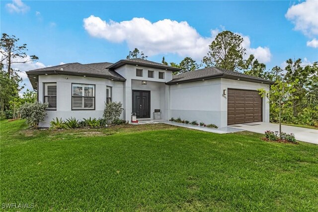 3905 15th St W, Lehigh Acres, FL 33971 - prairie-style home featuring concrete driveway, an attached garage, a front yard, and stucco siding
