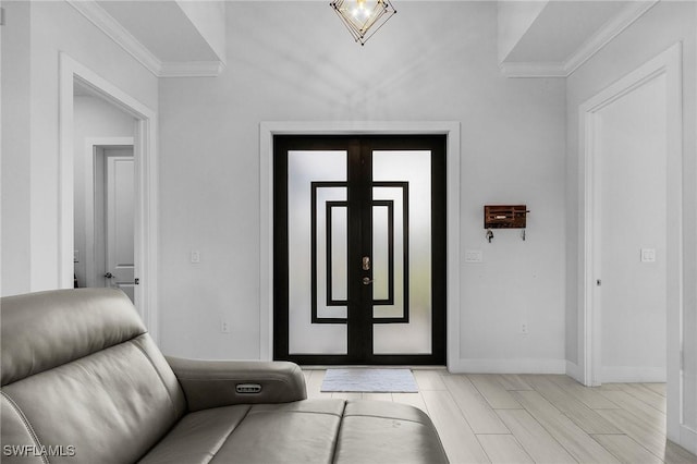 entrance foyer featuring crown molding and baseboards