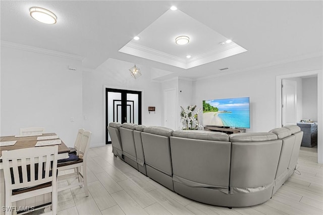 living area featuring crown molding, a tray ceiling, and recessed lighting