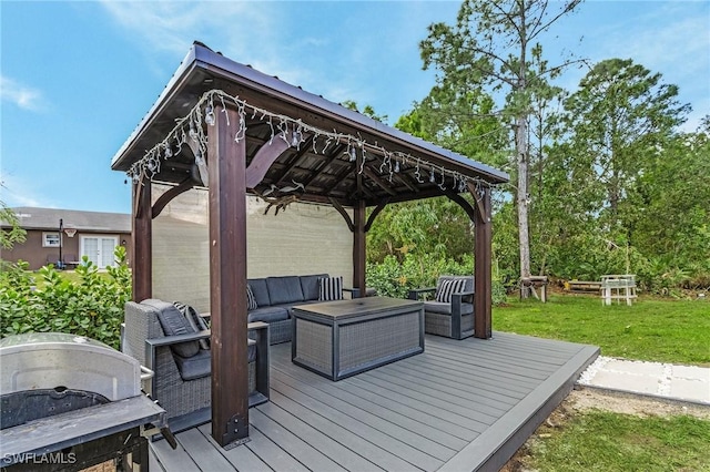 deck with grilling area, a gazebo, and an outdoor living space