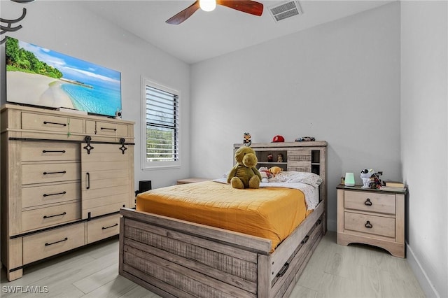 bedroom featuring baseboards, ceiling fan, and visible vents