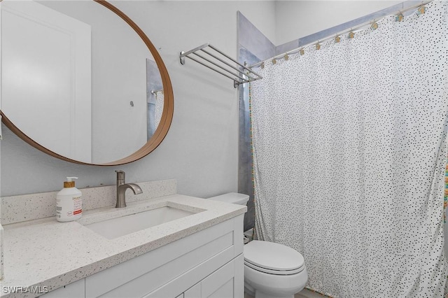 full bathroom with vanity, toilet, and curtained shower