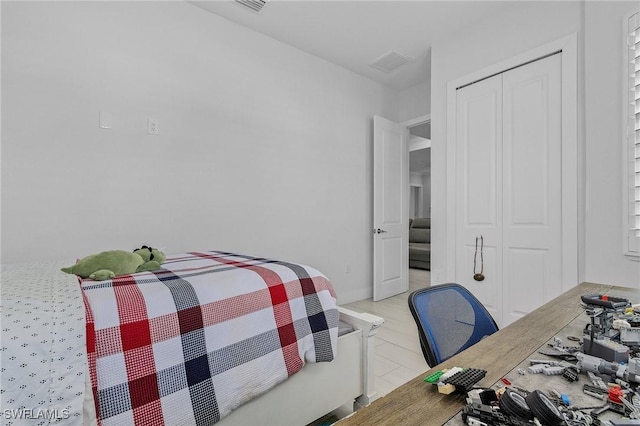 bedroom featuring visible vents and a closet