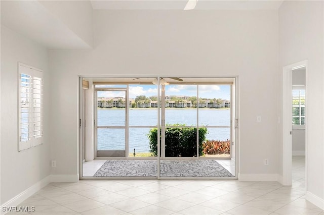 2524 Sailors Way Unit 118, Naples, FL 34109 - entryway with a healthy amount of sunlight, a water view, and baseboards