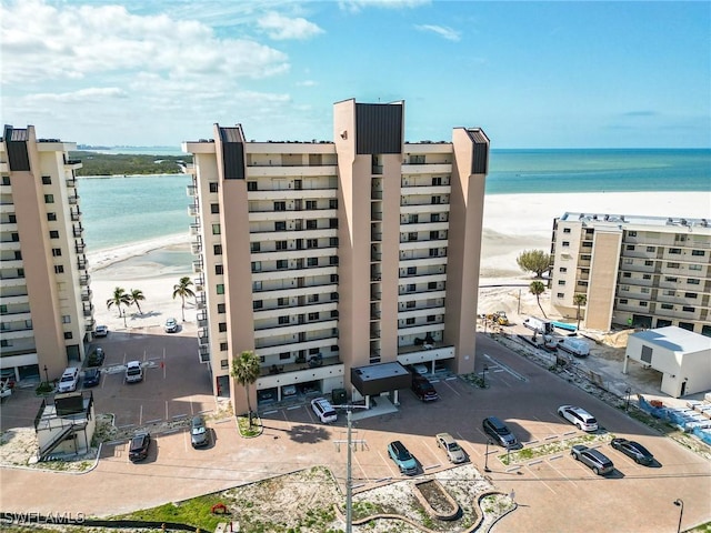 view of building exterior with a view of the beach and a water view