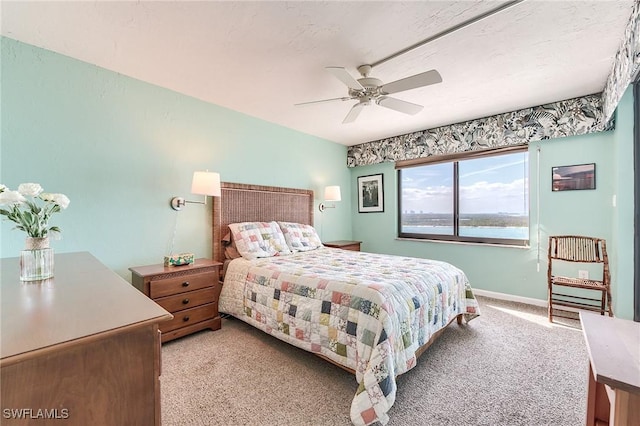 bedroom featuring baseboards, light carpet, and a ceiling fan