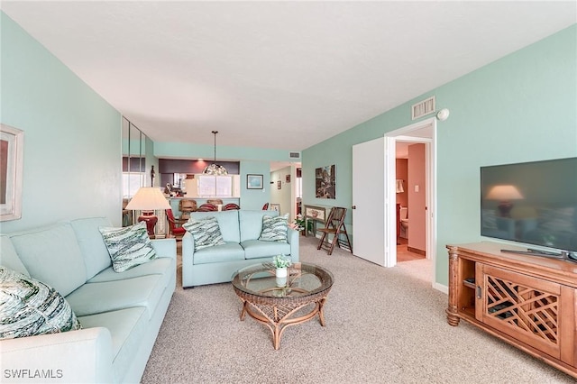 living room featuring visible vents and carpet