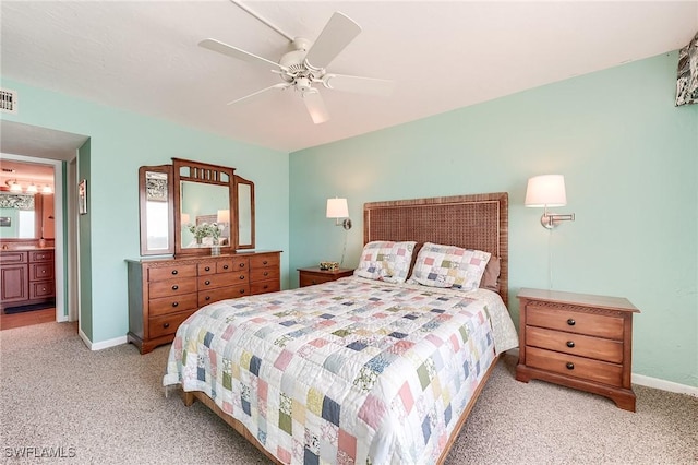 bedroom featuring baseboards, carpet flooring, a ceiling fan, and ensuite bathroom