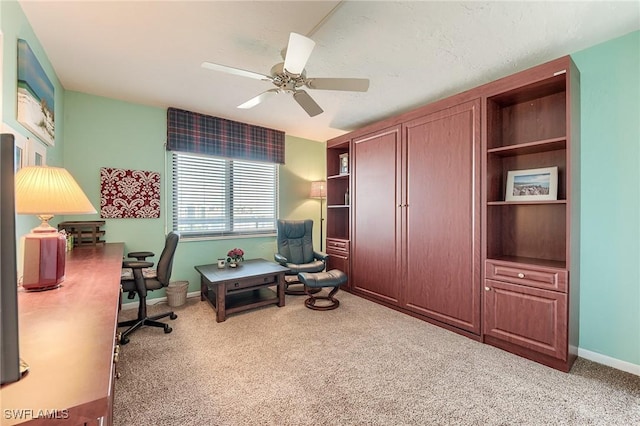 interior space with baseboards, ceiling fan, and carpet flooring