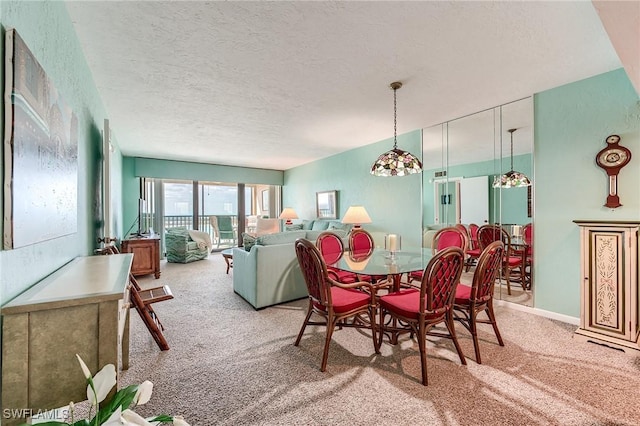 dining area featuring a textured ceiling and light carpet