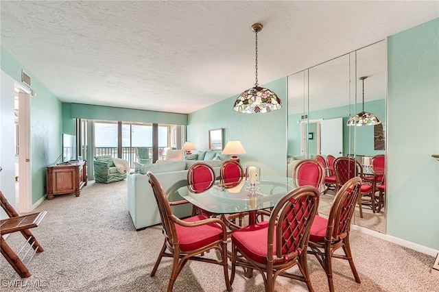 dining space featuring baseboards, light carpet, a textured ceiling, and visible vents