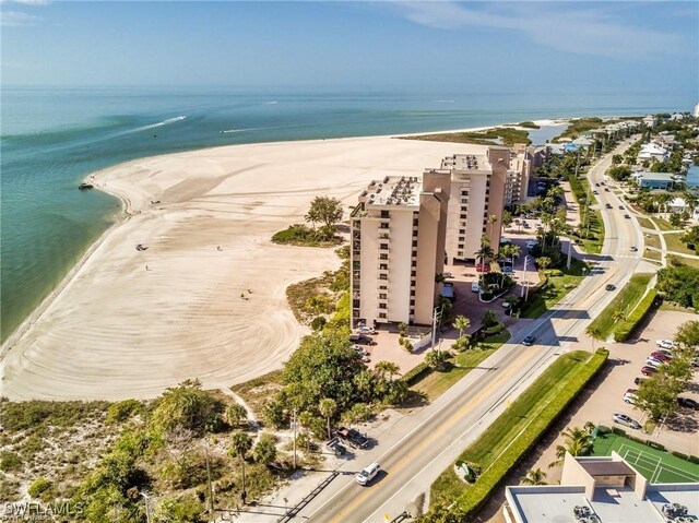 drone / aerial view with a beach view and a water view