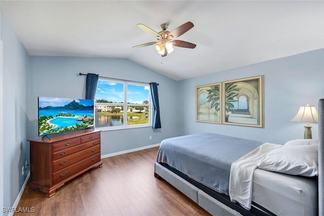 13760 Silver Lake Ct, Fort Myers, FL 33912 - bedroom with baseboards, ceiling fan, vaulted ceiling, and wood finished floors