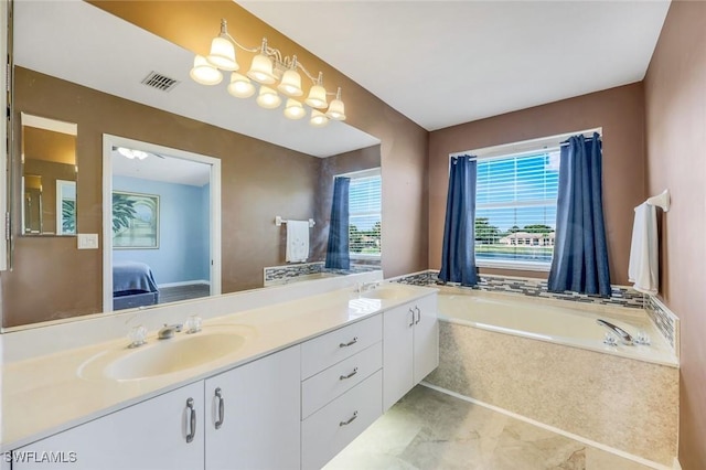 13760 Silver Lake Ct, Fort Myers, FL 33912 - ensuite bathroom with a sink, double vanity, ensuite bathroom, visible vents, and a bath