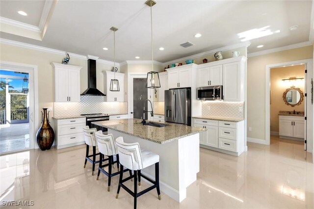 1978 San Marco Rd, Marco Island, FL 34145 - kitchen featuring appliances with stainless steel finishes, a sink, wall chimney exhaust hood, a breakfast bar, and white cabinetry