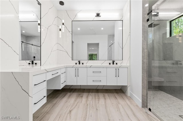 4693 13th Ave SW, Naples, FL 34116 - bathroom with double vanity, wood finished floors, a shower stall, and a sink