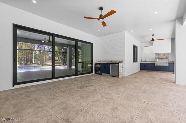 4693 13th Ave SW, Naples, FL 34116 - unfurnished living room with light tile patterned flooring, a sink, ceiling fan, and recessed lighting