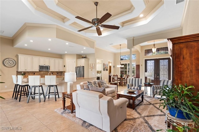 3824 SW 11th Pl, Cape Coral, FL 33914 - living room with crown molding, light tile patterned floors, ceiling fan with notable chandelier, and french doors