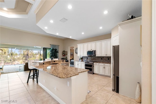 3824 SW 11th Pl, Cape Coral, FL 33914 - kitchen with visible vents, crown molding, light tile patterned flooring, a sink, and stainless steel appliances