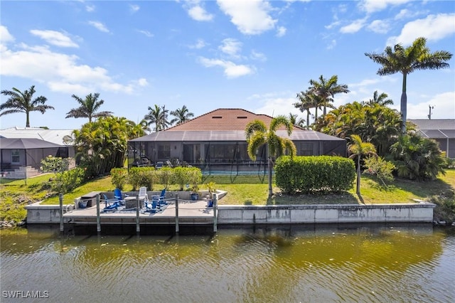 3824 SW 11th Pl, Cape Coral, FL 33914 - dock area with glass enclosure, a water view, and a yard