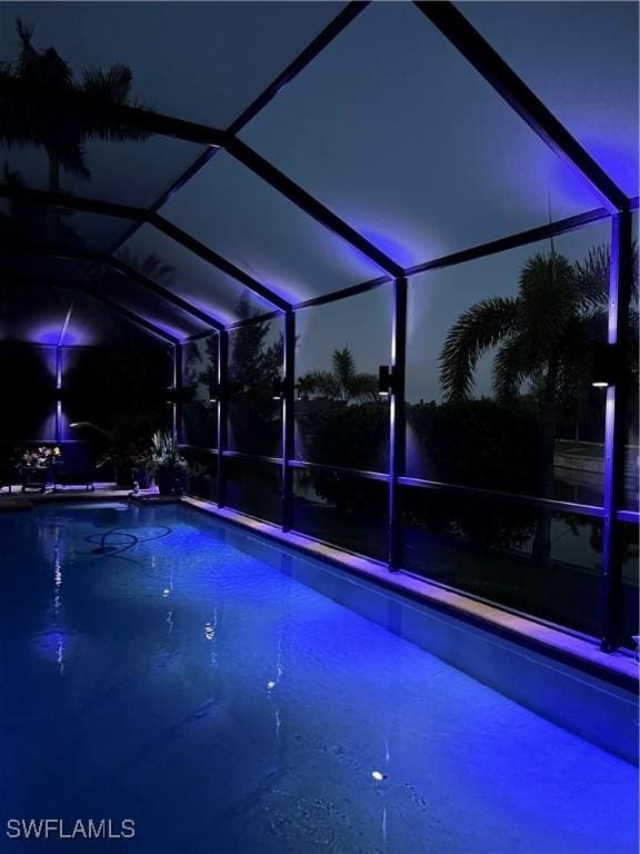 3824 SW 11th Pl, Cape Coral, FL 33914 - pool at night with an outdoor pool and a lanai