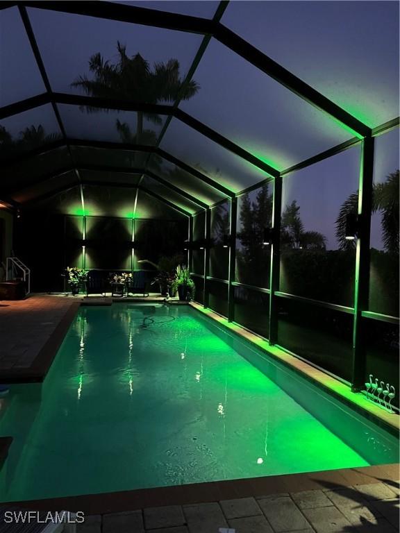 3824 SW 11th Pl, Cape Coral, FL 33914 - pool at night with an outdoor pool, a lanai, and a patio