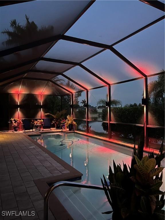 3824 SW 11th Pl, Cape Coral, FL 33914 - swimming pool featuring a patio area, a lanai, and a water view