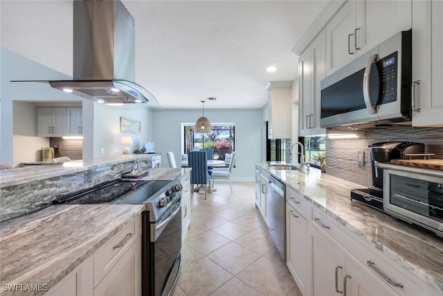 16902 Timberlakes Dr, Fort Myers, FL 33908 - kitchen featuring stainless steel appliances, island range hood, backsplash, a sink, and light stone countertops