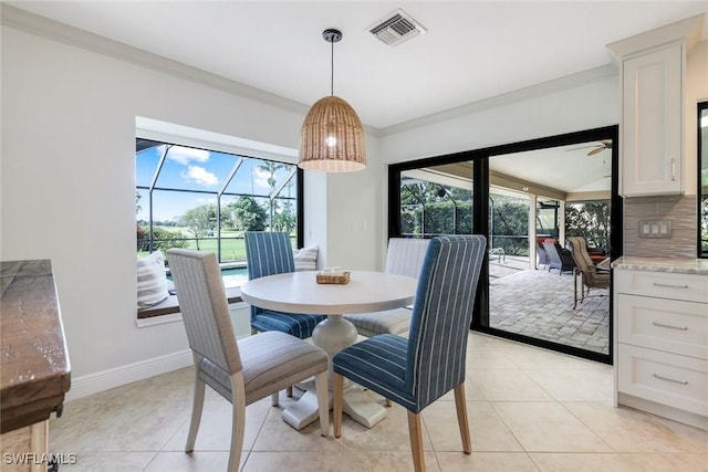 16902 Timberlakes Dr, Fort Myers, FL 33908 - dining space with healthy amount of natural light, ornamental molding, light tile patterned floors, baseboards, and ceiling fan