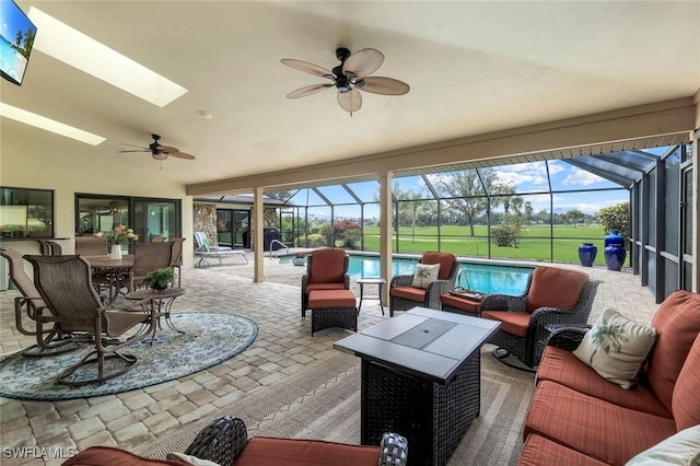16902 Timberlakes Dr, Fort Myers, FL 33908 - sunroom / solarium featuring a ceiling fan, an outdoor hangout area, vaulted ceiling, a pool, and a skylight