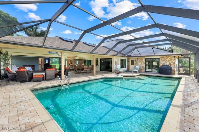16902 Timberlakes Dr, Fort Myers, FL 33908 - outdoor pool with a patio, an outdoor living space, glass enclosure, and outdoor dining area