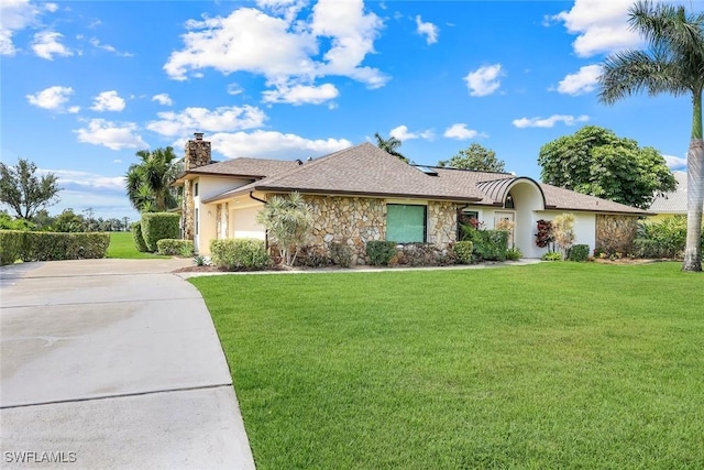 16902 Timberlakes Dr, Fort Myers, FL 33908 - ranch-style house with stone siding, a chimney, concrete driveway, an attached garage, and a front lawn