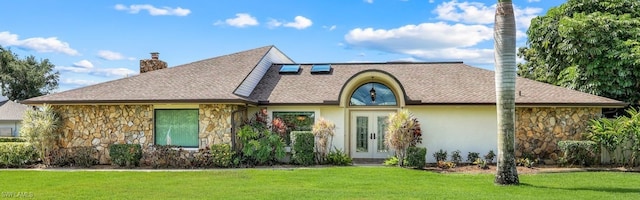 16902 Timberlakes Dr, Fort Myers, FL 33908 - view of front of property featuring french doors, stone siding, a front yard, and a chimney