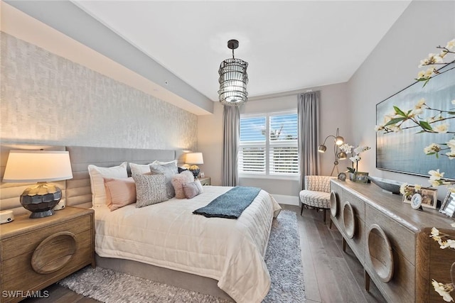 bedroom featuring wood finished floors and baseboards