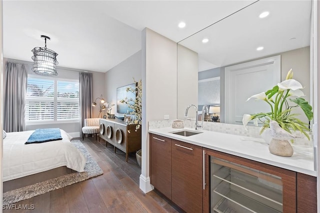 bar featuring recessed lighting, decorative light fixtures, baseboards, dark wood-style flooring, and a sink