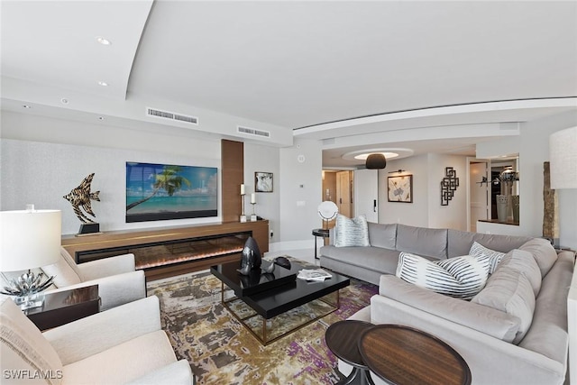 living area featuring visible vents and baseboards