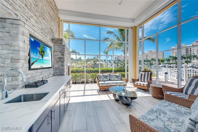 sunroom / solarium featuring a sink