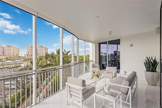 sunroom featuring a wall of windows, a view of city, and tile patterned floors