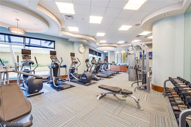 gym with carpet flooring, visible vents, baseboards, and a paneled ceiling