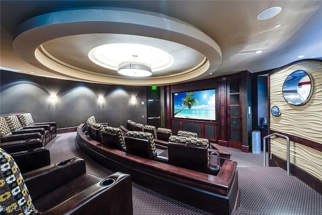 carpeted home theater with a raised ceiling, baseboards, and recessed lighting