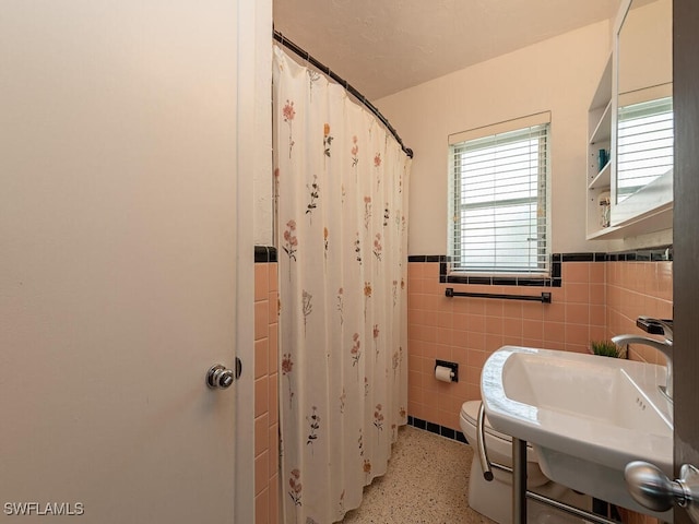 5521 Shaddelee Ln W, Fort Myers, FL 33919 - bathroom featuring a wainscoted wall, toilet, tile walls, a sink, and curtained shower