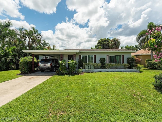 5521 Shaddelee Ln W, Fort Myers, FL 33919 - ranch-style house featuring a front yard, concrete driveway, a carport, and stucco siding