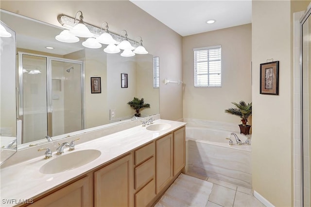 full bathroom featuring tile patterned floors, a garden tub, a shower stall, and a sink